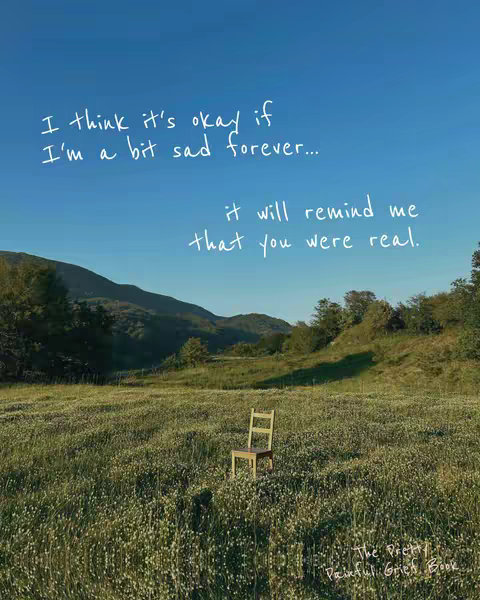 A serene outdoor scene with a clear blue sky and a field of wildflowers. A wooden chair stands alone in the field, conveying a sense of solitude and reflection. Hand-written text is overlaid on the sky, offering a comforting message about grief.