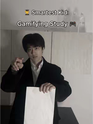 A man in a black coat holds a white sheet of paper with a serious expression, pointing towards the viewer. The background is a blurry, neutral shade. Text overlayed on the image reads, 'Smartest Kid: Gamifying Study' with a graduation hat and a gaming controller icon.