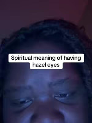 Close-up shot focusing on a person's eyes and a portion of their face. The background is dark, with text overlayed in a white rectangular box reading 'Spiritual meaning of having hazel eyes'.
