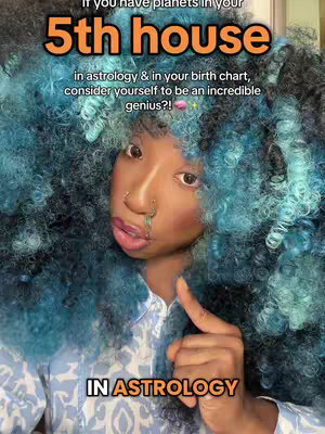 A close-up shot of a person with voluminous, blue-tinted afro-style hair. The person is looking towards the camera with a slight smile and a nose ring. Text overlays with a bright orange, and white, appear on the image detailing information about astrology.
