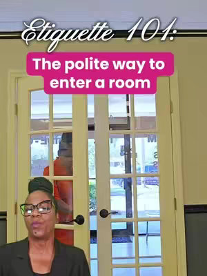 The image features a woman in front of a glass door entrance to a building. The woman, who is wearing glasses and a blazer, is positioned in the bottom left corner. Above her is a pink banner displaying the text: "The polite way to enter a room." The overall color scheme is neutral, with a focus on the woman and the door entrance.