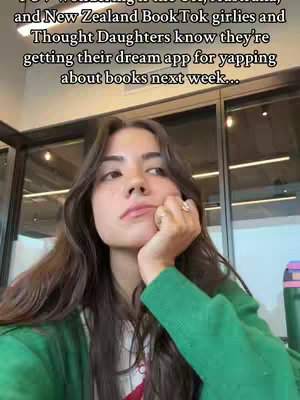 A young woman with long, dark hair is the central focus, her hand supporting her chin as she looks pensively upward. She is wearing a green sweater over a white top, with rings adorning her fingers. Behind her, a blurry background suggests an indoor setting with windows and overhead lighting. The overall tone is thoughtful and slightly introspective.