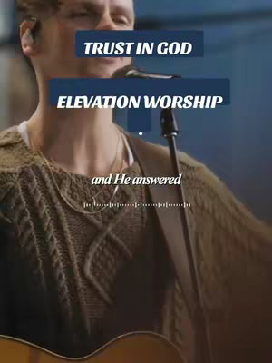 The cover image features a man playing a guitar and singing into a microphone. Text overlays include 'TRUST IN GOD' and 'ELEVATION WORSHIP', layered over the image. The lighting is soft, and the color palette is warm, with a focus on the man.