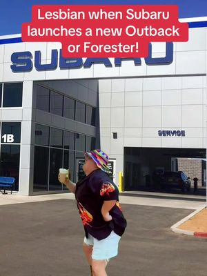 An individual stands in front of a Subaru dealership holding a beverage, with text overlay at the top.