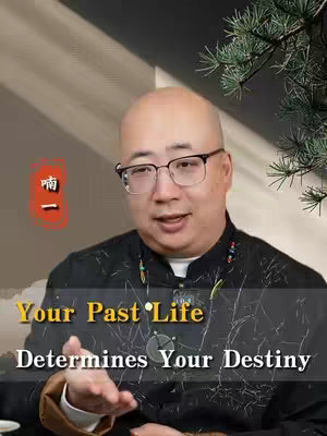 The image features a man with glasses centered in the frame, speaking directly at the camera. Text overlays at the bottom of the image states 'Your Past Life Determines Your Destiny'. Behind the man is a blurred background a leaf branch. A red rectangular graphic with Asian characters is placed in the upper left corner of the image.