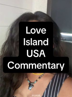 The cover image shows the upper body of a person with long, dark, wavy hair, likely a female. Their face is mostly obscured by the dark hair, but it appears they are in a well-lit area. A text overlay in a black rectangle covers a part of her face, with the words "Love Island USA Commentary" in white text. She has a beaded necklace with a unique pendant, and the background is blurred.