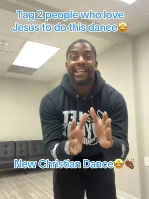 A man in a black hoodie stands in a room, gesturing with his hands. Text overlays read "Tag 2 people who love Jesus to do this dance" and "New Christian Dance".