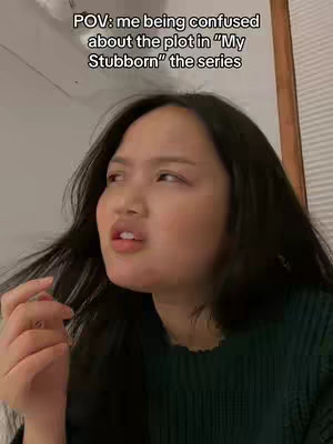 A woman with dark hair is shown from the chest up, looking off to the side with a slightly confused and concerned expression. Text overlays read: 'POV: me being confused about the plot in "My Stubborn" the series