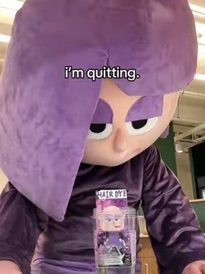 The image shows a person in a large purple costume head and purple clothing, with a package for hair dye in the foreground with the text overlayed.