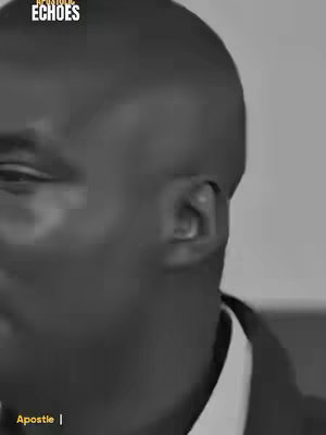 The cover image is a black and white medium close-up shot of a person's face. The person is a Black man wearing a suit with a white collared shirt and a dark colored tie. The left side of the face fills most of the frame. The person's skin is dark, and the features are somewhat obscured by the lighting. The background appears to be a plain wall. There is text from a logo in the top left corner: "SPIRITUAL ECHOES". Text at the bottom, "Apostle |" is also included.