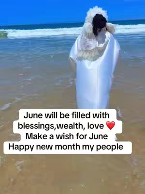 A person stands in the water at a beach. They are wearing a white outfit with a furry hood. Text overlays on the image.