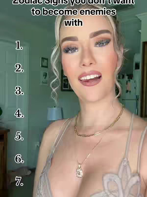 A selfie-style video with a woman in the frame. The top half of her body is visible. The text overlay displays a numbered list next to the woman’s face. Her hair is blonde and wavy and she is wearing makeup. The background setting appears to be a house interior with a light green door visible to the right.