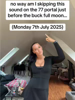 A woman in a black top and skirt stands in a room. Text at the top says, \"no way am I skipping this sound on the 77 portal before the buck full moon... (Monday 7th July 2025)\". The woman is pointing up. The room has slanted ceilings and a messy background.