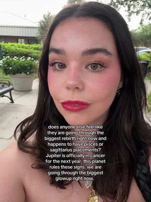 A selfie featuring a young woman with dark hair and heavy blush, outdoors. Text is overlaid on the image.
