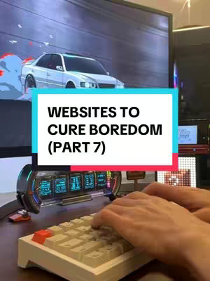 The image shows a person typing on a keyboard with a large computer monitor in the background. The monitor shows a scene of a car racing, with a text overlay at the center. The scene is well-lit, with cool tones dominating the scene.