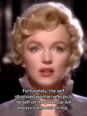 The cover image captures a close-up of Marilyn Monroe, the iconic actress, facing the viewer. She is wearing a soft-colored, possibly lavender-grey, dress. The background appears blurred, likely emphasizing her as the subject. Below her face, overlaid in black text, a quote is present.