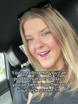 A woman with blonde hair and green eyes is smiling and looking directly into the camera. She wears sunglasses on top of her head, and the interior of a car is visible in the background, along with text overlaid on the image.