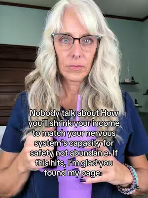 A selfie-style video with a woman in the center. She has long, wavy, gray hair, is wearing glasses, and looking directly at the camera with a serious expression. She is holding a purple cup with a straw. Overlayed text in a casual font is placed above and below.