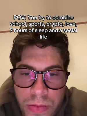 A close-up shot of a young man wearing eyeglasses, looking directly at the camera. Overlayed on the image is white text in a bold font.