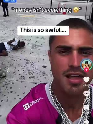 A man with a serious expression is filming a video in an outdoor setting. The image is primarily focused on the man with a few overlaid text elements. In the background, a person appears to be incapacitated. The overall feel might be related to a serious or dramatic event.