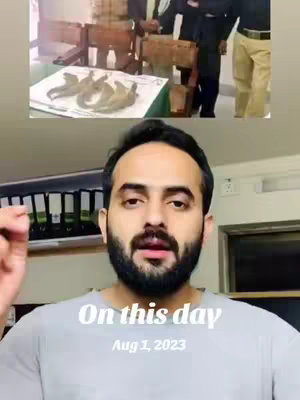 The image is a vertical screen recording split into two sections. The upper half shows a room with a table, chairs, and people interacting, against an old-looking backdrop. The lower half shows a bearded man in a gray shirt, talking directly at the camera. Text reading "On this day" and "Aug 1, 2023" is overlaid on the lower portion.