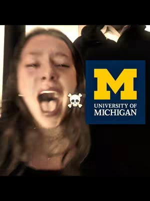 A young woman exclaims joyfully with her mouth open wide on the left. A small skull icon is to her right, partially obscured. On the right side, the University of Michigan's logo appears in a dark blue rectangle with a yellow 'M'.