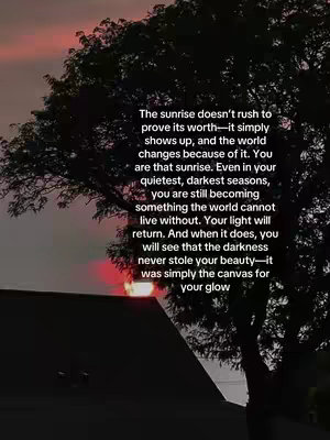 The image shows a sunset with a dark tree silhouetted in front. The sky transitions from dark red to lighter shades of red and orange. A portion of a building is visible in the lower part of the frame. The dominant colors are dark shades of red, orange, and black, creating a contemplative and somewhat somber mood.
