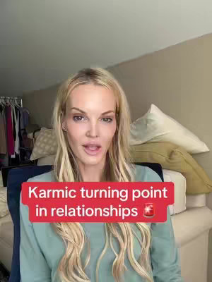 A woman with long blonde hair smiles at the camera. Text overlayed on a red box states, 'Karmic turning point in relationships.' The background includes hints of a bed and closet.