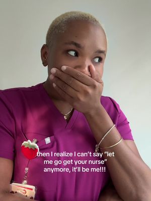 A woman with short blond hair is seen close up, covering her mouth with her hand while looking to her right with an expression of mock surprise or nervousness. She wears a purple scrub top with a name badge that has a strawberry design. Text is overlaid, explaining her current reaction.