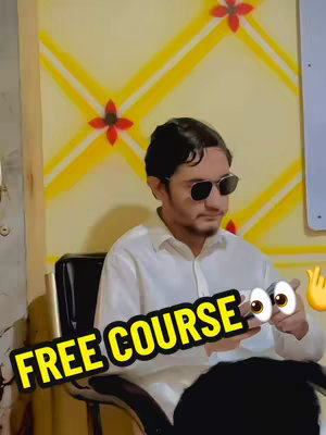A man in sunglasses and a white shirt sits in front of a yellow wall with red flower-shaped decorations. Text overlays that say "FREE COURSE". He is holding a phone.
