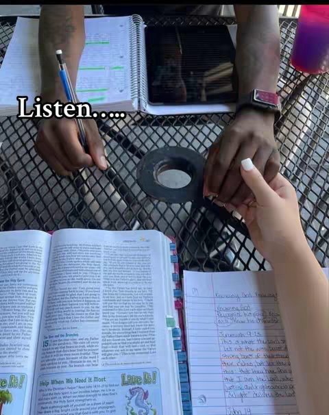 The cover image features an open book with the Bible on the left, a hand holding a pen, and a piece of paper with handwritten notes, and holding hands with someone else. The layout is from a top-down angle with all elements resting on a textured, dark surface, and a clear hook text at the top; a background with a black and white pattern.
