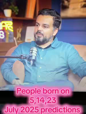 A man with a beard sits in a chair with a microphone in front of him. The background is blurred, with a sign that reads 'STAR'. Text overlays the bottom third of the image, stating 'People born on 5,14,23 July 2025 predictions' in a pink neon style.