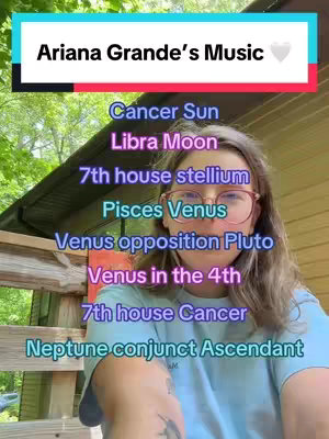 A woman with glasses is centered in the frame, with colored text overlays detailing astrological placements, such as Cancer Sun and Libra Moon. The background shows an out-of-focus natural setting.