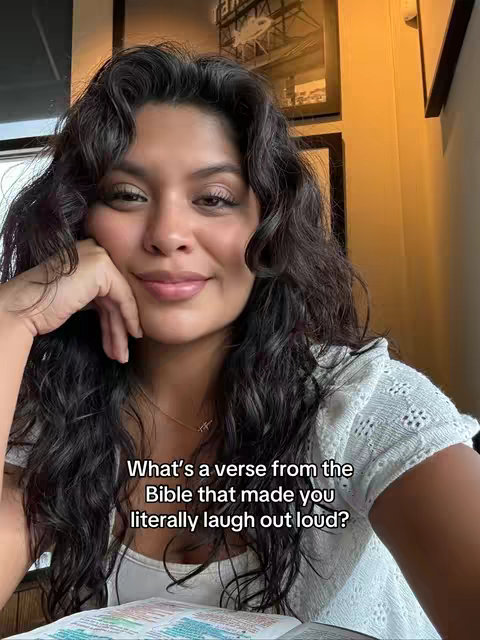 A woman with long, dark, wavy hair smiles slightly, resting her hand on her cheek. She wears a white, textured top. Text overlaid on the image asks a question about a Bible verse.