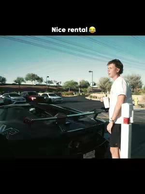 The cover image shows a man standing near a black supercar, possibly a rental. He's holding a cup, perhaps of coffee or a beverage. The setting is an outdoor area, likely a parking lot or street, with other cars visible in the background. The phrase "Nice rental" is overlaid at the top.