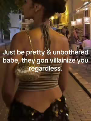 A woman is captured from the back as she walks along a cobblestone street. She's wearing a striped top and a sequined skirt. Text is overlaid on the image, and the background features buildings and evening lighting.