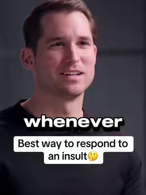 A man with fair skin and short brown hair is in the center of the frame, slightly off-center to the right and smiling slightly, with a black long-sleeved shirt. The top portion of his body is visible and the background appears to be a minimalistic, solid color or slightly out-of-focus environment. The video has a text overlay in white font: 'whenever' in a bold font at the top and 'Best way to respond to an insult 🤔' in a smaller font.