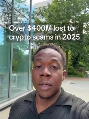 A man with dark skin and short, dark hair looks directly at the camera. He wears a black collared shirt and is outside; a building with large glass windows is behind him to the left, and lush green trees are to the right. Text overlays at the top state, "Over $400M lost to crypto scams in 2025."