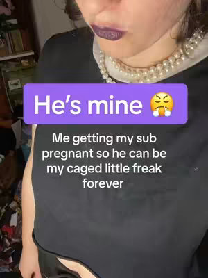 A close-up shot featuring the lower face of a person, likely a woman, with deep purple lipstick. A pearl necklace with a white collar detail is visible. Overlaid are two text boxes. The first box, in a purple rectangle, reads "He's mine," with an exasperated emoji. Below this, a text box states, "Me getting my sub pregnant so he can be my caged little freak forever."