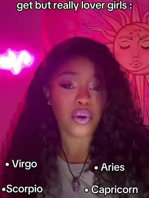 A woman with long, dark hair and makeup is centered in the image, set against a background glowing with pink neon light. She's looking at the camera with a subtle expression, and text overlays are added. The image is lit in a way that casts a soft glow and highlights her features.
