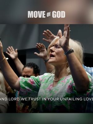 The cover image shows a group of people, likely in a church or worship setting, with their hands raised in praise. The focus is on a woman with blonde hair and glasses, who is looking up and has her hands raised. The background is blurred, suggesting a focus on the worshipers and the atmosphere of the event. There's text overlayed at the top, and at the bottom of the screen.