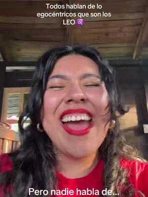 A selfie-style video with a woman laughing, her red lipstick and open mouth in focus. Text overlays are present at the top and bottom.