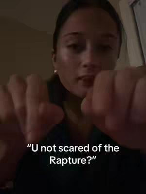 A person with light skin looks at the camera, while holding their hands up with their fists towards the viewer; the text overlayed on the image says "U not scared of the Rapture?"