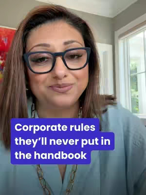 The cover image is a selfie-style shot featuring a woman with brown hair and glasses, facing the camera. She is wearing a teal colored top and a gold chain necklace. There is a purple and white rectangular text overlay on the bottom that says "Corporate rules they'll never put in the handbook". The background is a blurred setting with what appears to be a window.