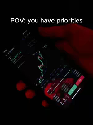 The image shows a close-up of a smartphone screen displaying a stock chart overlaid by a hand. The overall color scheme is dark with red accents, creating a sense of urgency or seriousness.