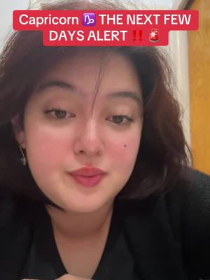A close-up shot features a woman with fair skin, brown hair, and a black top. A red banner with white text reading 'Capricorn THE NEXT FEW DAYS ALERT !!' overlays the top of her head. The woman is looking down at her left side and the background is an off-white color.