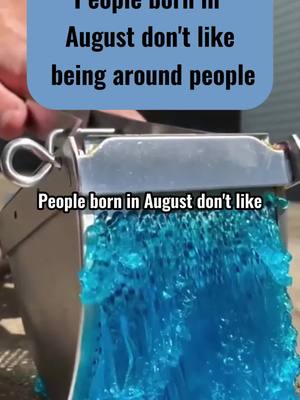 An image showing a close-up of a silver device pouring out a stream of vibrant blue liquid, suggestive of a refreshing or cooling substance. The top has text that states something about people born in August.