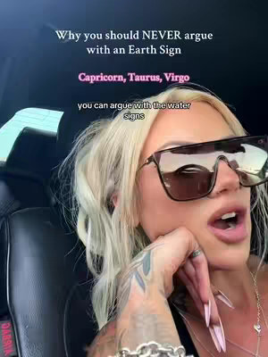 A woman with long blonde hair and large sunglasses, in a car cabin. Text overlays her head, and the woman appears to be speaking. The setting is informal.
