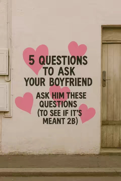 The image shows a white wall with text and pink heart shapes. The text reads "5 QUESTIONS TO ASK YOUR BOYFRIEND" in large black letters. Below this, in smaller black text, it continues, "ASK HIM THESE QUESTIONS (TO SEE IF IT'S MEANT 2B)". There are five pink heart shapes spread across the image. To the right, is a wooden door.