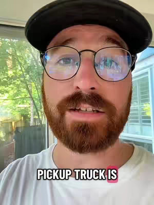A man with a red beard, mustache, glasses, and a black cap looks at the camera, with text overlayed at the bottom.